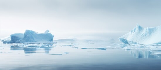 Wall Mural - icy winter landscape with foggy weather, pure ice chunks, drifting from melting glacier in calm wate