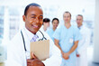 © STEEX/peopleimages.com - Doctor, black man and portrait of clipboard with medical, healthcare and clinic staff in a hospital. Teamwork, job and stethoscope of a nurse and surgeon with professional team ready for working