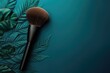 Tropical palm leaves and cosmetic brush on turquoise background. Copy space for product presentation. Top view.