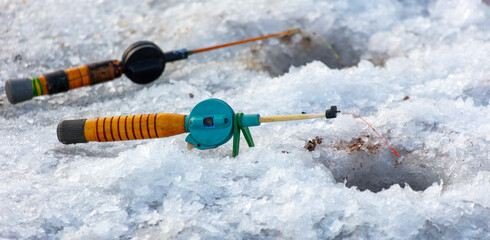 Sticker - Fishing rod on ice in winter. Ice fishing