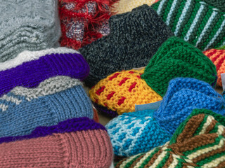 Wall Mural - Colorful wool knitted socks for children handmade for the cold season. Things made of natural yarn. Winter clothes made of natural wool.  Knitting with needles.