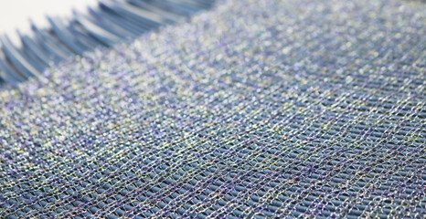 Closeup silver and blue fiber fabric pattern texture.
