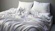White folded duvet lying on white bed background