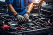 Expert mechanical with gloves repairing car battery and engine