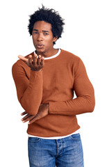 Sticker - Handsome african american man with afro hair wearing casual clothes looking at the camera blowing a kiss with hand on air being lovely and sexy. love expression.