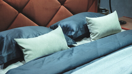 Poster - Interior of a modern bedroom in an apartment, hotel or private house with a bed and pillows