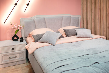 Poster - Interior of a modern bedroom in an apartment, hotel or private house with a bed and pillows