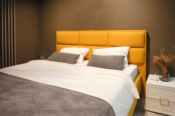 Poster - Interior of a modern bedroom in an apartment, hotel or private house with a bed and pillows