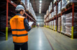 Warehouse Audit and Inspection: Safety Officer Wearing Correct PPE, Checking Checklist Document