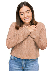 Sticker - Young beautiful woman wearing casual clothes smiling with hands on chest with closed eyes and grateful gesture on face. health concept.