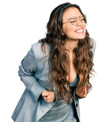 Sticker - Young hispanic girl wearing business clothes and glasses very happy and excited doing winner gesture with arms raised, smiling and screaming for success. celebration concept.