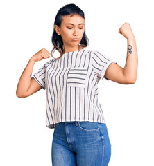 Wall Mural - Young woman wearing casual clothes showing arms muscles smiling proud. fitness concept.