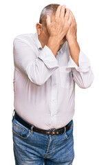 Canvas Print - Handsome senior man wearing elegant white shirt with sad expression covering face with hands while crying. depression concept.