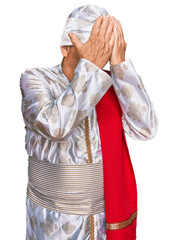 Poster - Senior hispanic man wearing tradition sherwani saree clothes with sad expression covering face with hands while crying. depression concept.