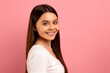 © Prostock-studio - Attractive teen girl with beautiful smile looking over her shoulder at camera
