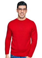 Wall Mural - Handsome hispanic man wearing casual clothes and glasses with a happy and cool smile on face. lucky person.