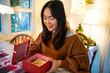 © Charlie's - Happy excited asian woman hands holding Christmas gift box. cheerful girl packing Xmas present or open box xmas new year birthday gift.