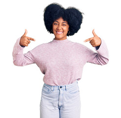 Poster - Young african american girl wearing casual clothes looking confident with smile on face, pointing oneself with fingers proud and happy.