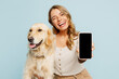 Young owner woman with her best friend retriever wear casual clothes use blank screen area mobile cell phone hug dog wink isolated on plain pastel light blue background . Take care about pet concept.