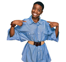 Poster - Young african american woman wearing casual clothes looking confident with smile on face, pointing oneself with fingers proud and happy.