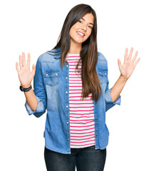 Sticker - Young brunette woman wearing casual clothes showing and pointing up with fingers number ten while smiling confident and happy.