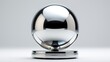 A reflective spherical ball on a stand, with a stark contrast between its reflective surface and the grey background