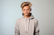 © MagnusCort - A young boy wearing a grey hoodie looks at the camera