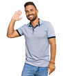 © Krakenimages.com - Handsome man with beard wearing casual clothes waiving saying hello happy and smiling, friendly welcome gesture