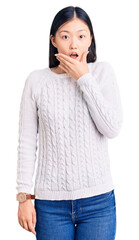 Sticker - Young beautiful chinese woman wearing casual sweater looking fascinated with disbelief, surprise and amazed expression with hands on chin