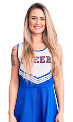 Canvas Print - Young beautiful blonde woman wearing cheerleader uniform with a happy and cool smile on face. lucky person.