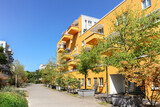 Fototapeta Londyn - Residential area with ecological and sustainable green residential buildings, low-energy houses with apartments and green courtyard