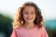 © MagnusCort - A young girl in a pink shirt smiles for the camera