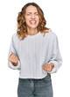 © Krakenimages.com - Beautiful young caucasian woman wearing casual winter sweater very happy and excited doing winner gesture with arms raised, smiling and screaming for success. celebration concept.