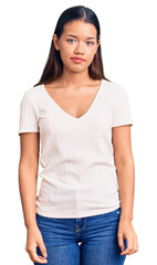 Sticker - Young beautiful latin girl wearing casual white t shirt with serious expression on face. simple and natural looking at the camera.