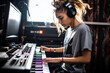 A woman wearing headphones is playing a piano