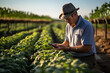 © Gonzalo - farmer using a smartphone app. smart farm concept