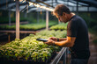© Gonzalo - farmer using a smartphone app. smart farm concept