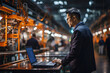 © Gonzalo - Architectural engineer use laptop checks and control automation robot arms machine in an intelligent factory Industry 4.0