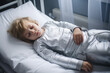Child boy is sad lying on the bed and holding his stomach. Abdominal pain in children, symptoms of gastritis, poisoning and intestinal infection, abdominal bloating.