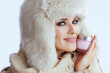 © Alliance - happy stylish woman in winter coat and fur hat on white