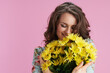© Alliance - smiling trendy 40 years old woman in floral dress on pink