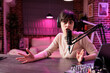 © DC Studio - Portrait of entertaining social media celebrity filming live show from her home studio, talking to internet channel audience. recording vlogging episode using professional tools