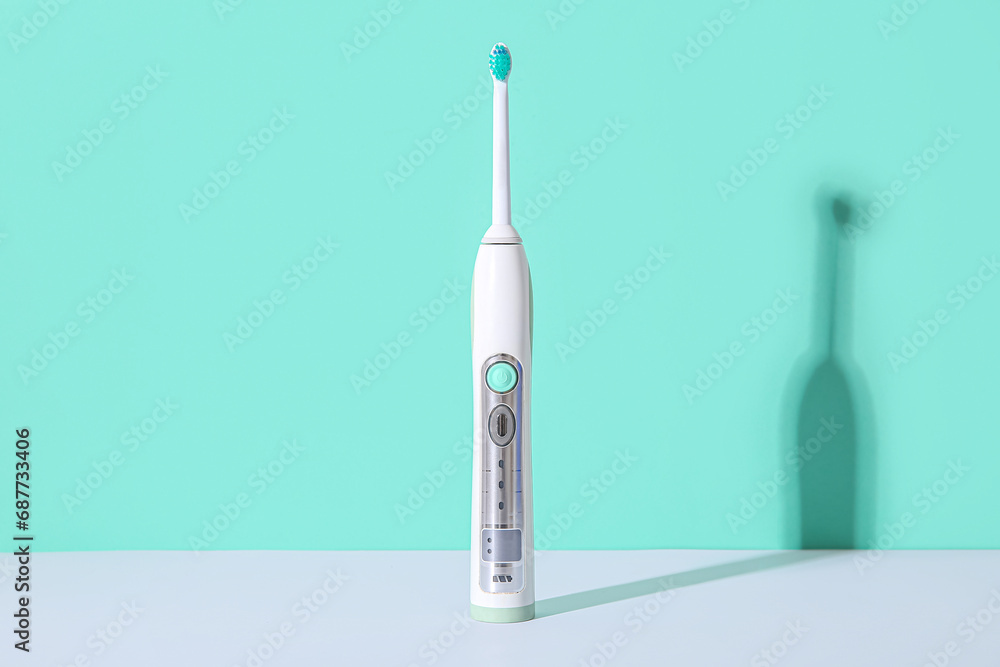 Electric toothbrush on color background.