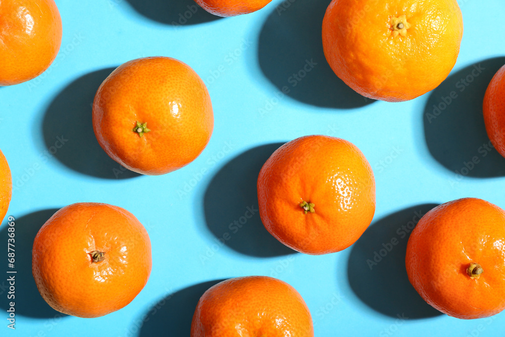 Many sweet mandarins on blue background
