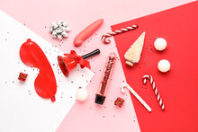 Composition with Christmas decorations and sex toys on color background