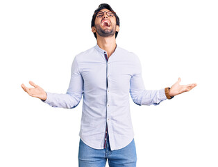 Poster - Handsome hispanic man wearing business shirt and glasses crazy and mad shouting and yelling with aggressive expression and arms raised. frustration concept.