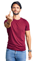 Poster - Handsome hispanic man wearing casual clothes showing middle finger, impolite and rude fuck off expression