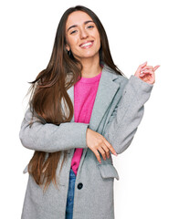 Sticker - Young hispanic girl wearing business clothes with a big smile on face, pointing with hand and finger to the side looking at the camera.