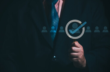 HRM or Human Resource Management, Businessman holding Magnifying glass focus to manager icon which is among staff icons for human development recruitment leadership and customer target group concept.