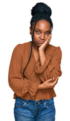 Sticker - Young african american woman wearing casual clothes thinking looking tired and bored with depression problems with crossed arms.